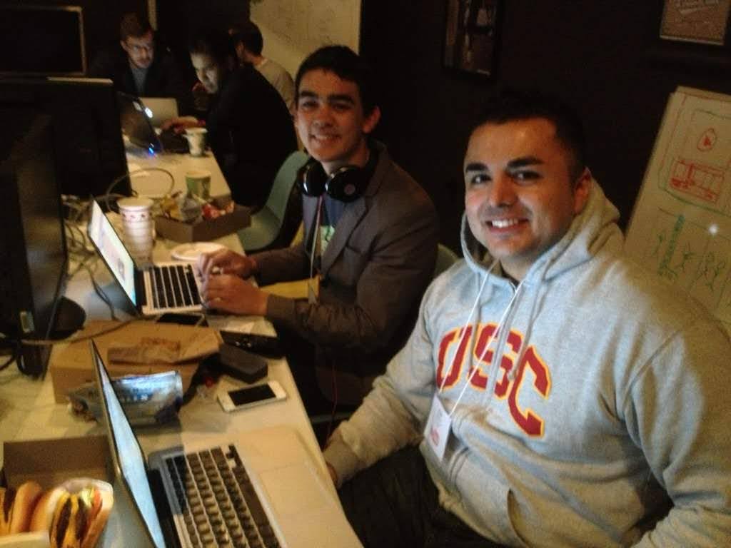 Founders at hackathon building and presenting